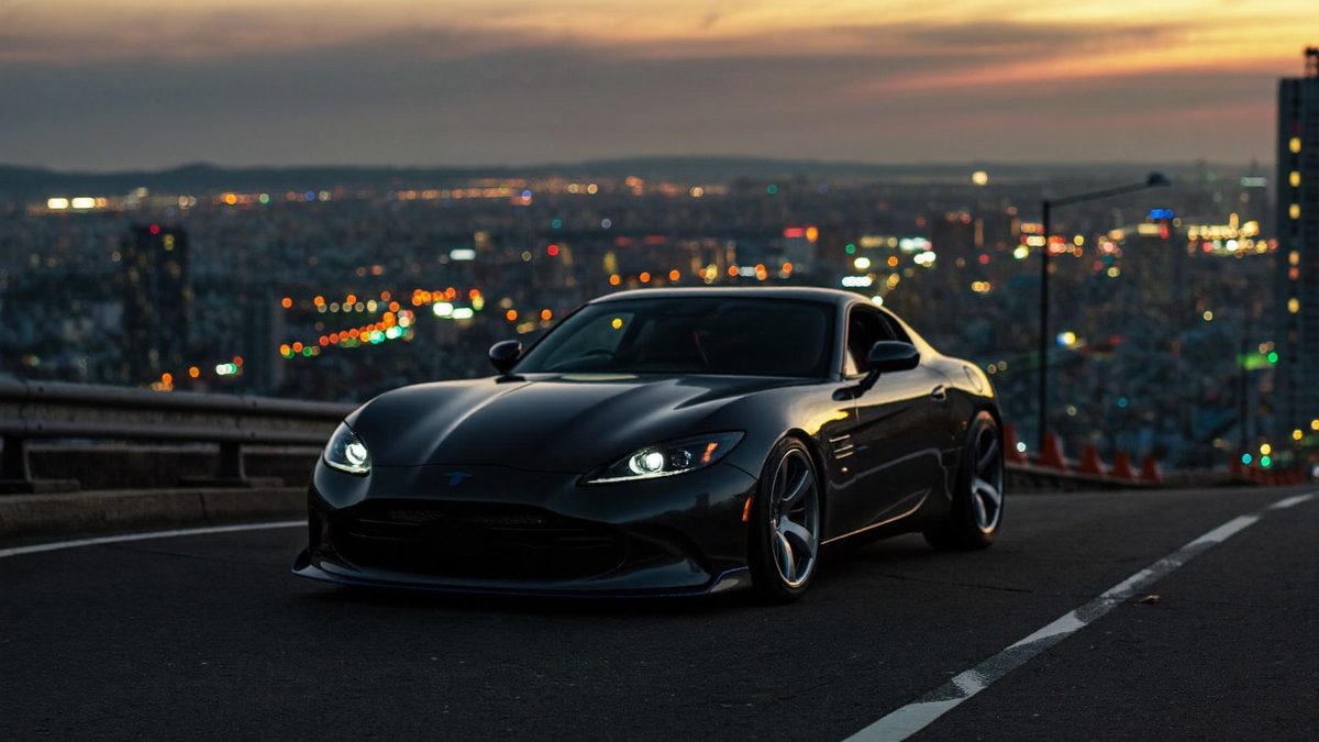 Moodboard: sports car above a city at dusk