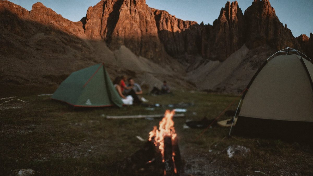 Moodboard: camp fire and tents under red cliffs