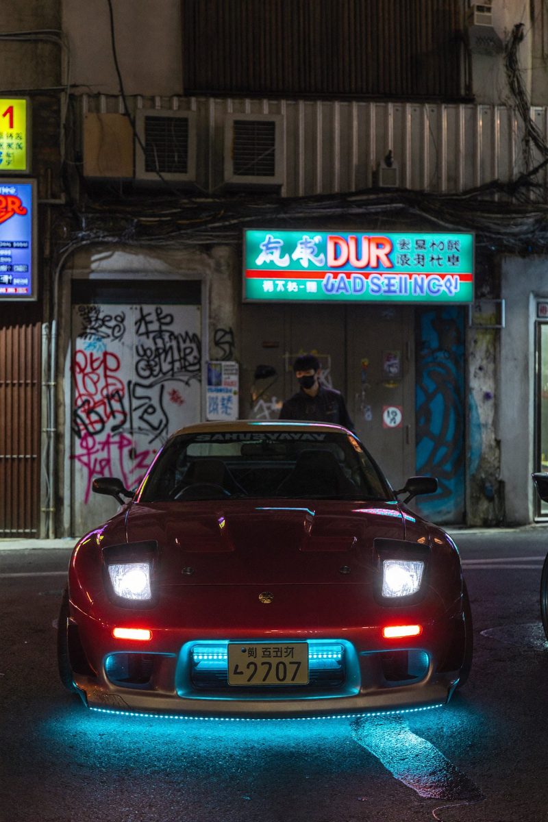 Moodboard: red car in a neon alley